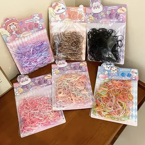 Detailed view of colorful elastic hair bands in cute cartoon packaging sets
