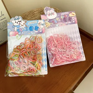 Detailed view of colorful children's hair elastics sets in cute cartoon rabbit packaging.