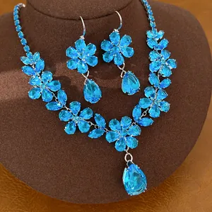 Dettaglio dell'elegante set di collana a fiori in zircone blu e orecchini a goccia coordinati.