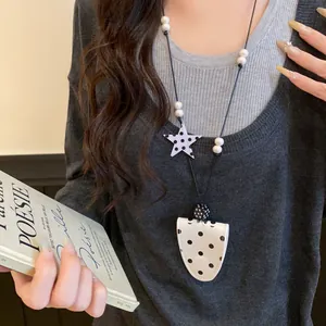 Close-up of a Korean style polka dot leather magnetic glasses clip necklace for women.
