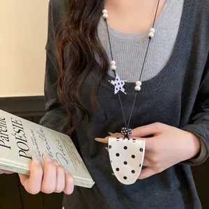 Close-up detail of a stylish polka dot magnetic leather glasses holder necklace for women