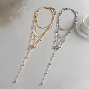 Detail of multi-layer Y-shaped pearl necklace with sparkling zircon star pendant.