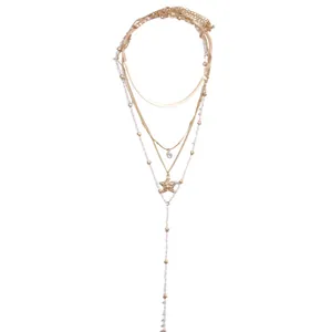 Multilayered Y-shaped gold necklace with pearls, stars and a sparkling crystal pendant.