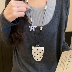 Polka dot leather magnetic glasses clip necklace worn as a stylish sweater chain accessory