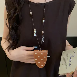 Detail view of stylish polka dot leather magnetic glasses clip necklace for women