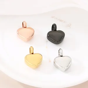 Close-up of heart-shaped pendants in rose gold, gold, silver, and black polished metal.