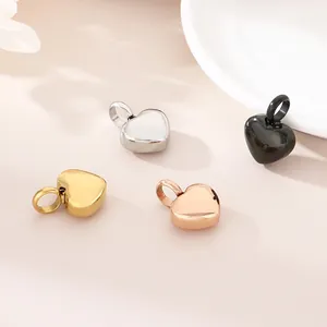 Detailed macro view of polished heart pendants in gold, silver, rose gold and black.