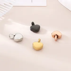 Detailed view of four colorful heart pendants in steel, gold, rose gold and black colors