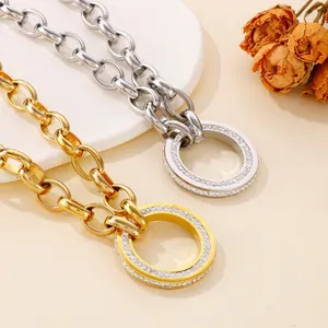 Chunky stainless steel O-chain necklaces featuring crystal-encrusted circular pendants.