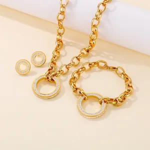 Chunky gold stainless steel jewelry set with sparkling crystal-paved circular pendants