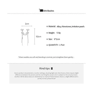 Spécifications détaillées des boucles d'oreilles élégantes à pompons papillon de style français.
