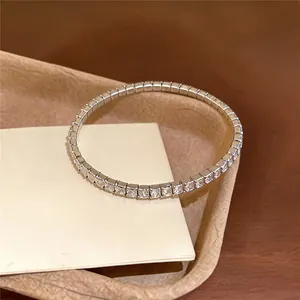 Close-up detail of a silver-toned elastic bracelet with square-cut rhinestones