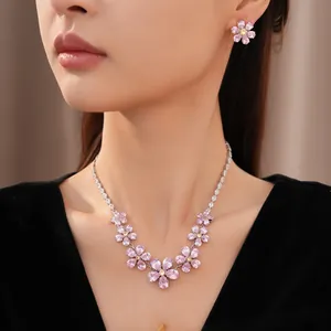 Detail view of elegant pink and yellow zircon flower necklace and matching earring set