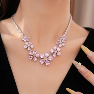 Detailed close-up of a sparkling pink zircon flower necklace on a model's neck