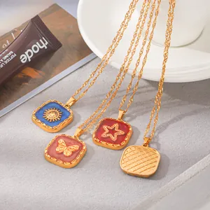 Close-up of vintage stainless steel enamel necklaces with butterfly and star pendants