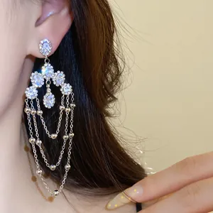 Elegant multi-layered silver tassel drop earrings with sparkling rhinestones detail view