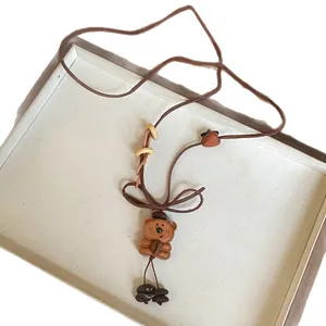 Handmade wooden bear pendant necklace with coffee bean accents and brown cord style