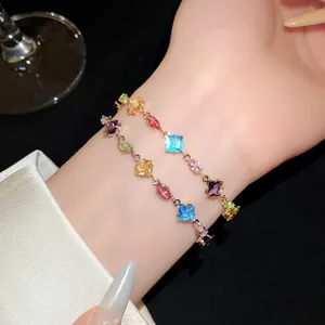 Detailed view of two colorful cubic zirconia bracelets with rhombic and oval stones on a wrist