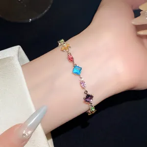 Close-up of a colorful zircon bracelet featuring diamond and oval shapes on a wrist
