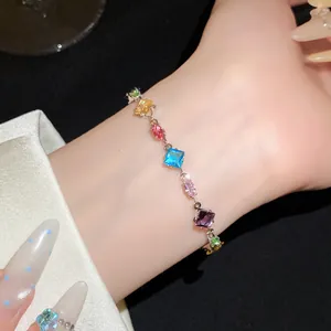 Macro detail of elegant zircon bracelet with colorful multi-shape gemstones on wrist