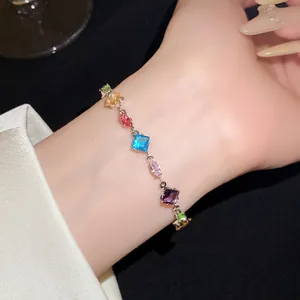 Elegant detailed view of a colorful zircon bracelet featuring diamond and oval stones on a wrist