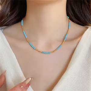 Gros plan détaillé d'un collier de perles turquoise et or sur un mannequin asiatique