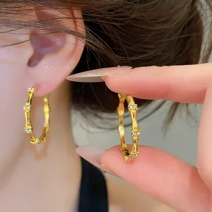 Detailed view of New Chinese style gold bamboo joint hoop earrings with zircon accents.