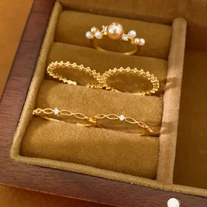 Nahaufnahme eines eleganten 18-karätig vergoldeten Ring-Sets mit Perlen und Zirkonia