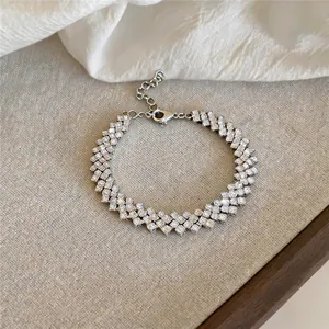 Detailed macro view of an elegant multi-row rhinestone bracelet on neutral fabric.