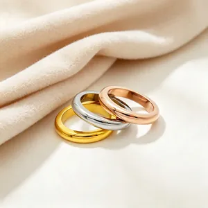Stackable polished stainless steel band rings in gold, silver, and rose gold colors