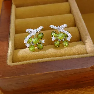 Detailopname van elegante groene glazen bloemknopjes met zirkonia in een sieradendoosje