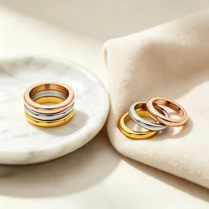 Detail view of polished stainless steel stackable rings in gold, silver, and rose gold