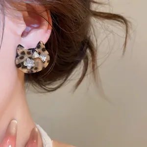 Close-up view of a vintage leopard print cat stud earring with sparkling rhinestones
