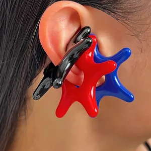 Detailed close-up of vibrant blue, red, and black starfish-shaped acrylic ear cuffs