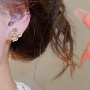 Macro view of vintage zircon flower clip-on earring featuring sparkling petals on ear