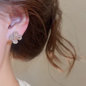 Detail shot of vintage zircon flower clip-on earring worn on ear with soft lighting