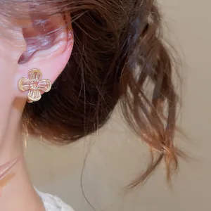 Detailed view of vintage zircon flower ear clip for non-pierced ears in gold finish