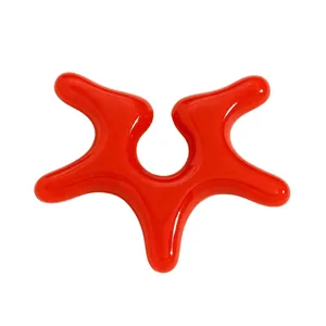 Detail of a glossy red acrylic ear cuff with an irregular starfish-inspired shape