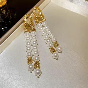 Élégantes boucles d'oreilles vintage dorées géométriques avec glands en doubles perles