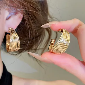 Elegant gold multi-layer striated hoop earrings designed for a minimalist luxury look