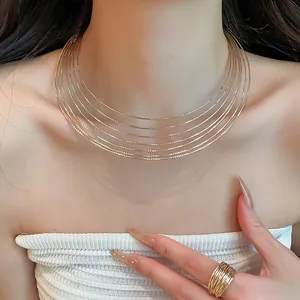 Close-up of elegant gold multi-layer metal choker and matching ring set on model