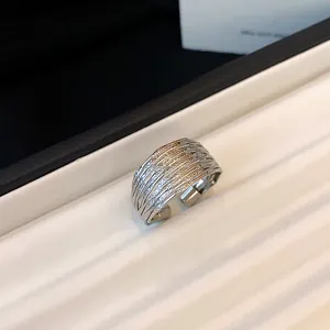 Detailed macro shot of a silver multi-layer textured metal adjustable open ring