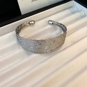 Close-up detail of the textured silver multi-layer wide metal cuff bracelet in a jewelry tray