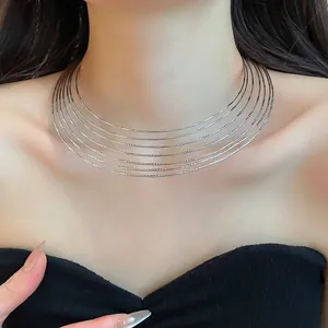 Close-up detail of silver multi-layer metal choker necklace with textured finish