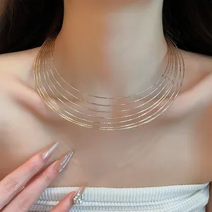 Detailed macro view of a multi-layer golden wire choker necklace on a female model's neck