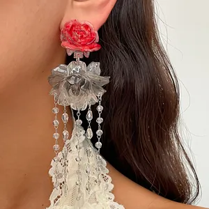 Close-up detail of retro resin rose earrings featuring sparkling crystal flower tassels.