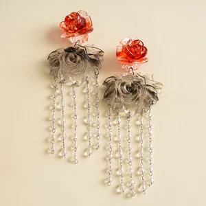 Detailed view of vintage resin earrings with stained glass roses and crystal beaded tassels