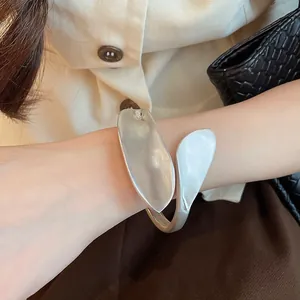 Close-up of vintage geometric leaf silver cuff bracelet with matte brushed finish on wrist