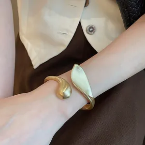 Detailed view of a vintage gold leaf cuff bracelet with a unique matte and polished finish.