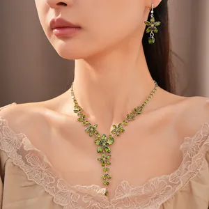 Close-up of elegant green zircon flower necklace and matching earring jewelry set